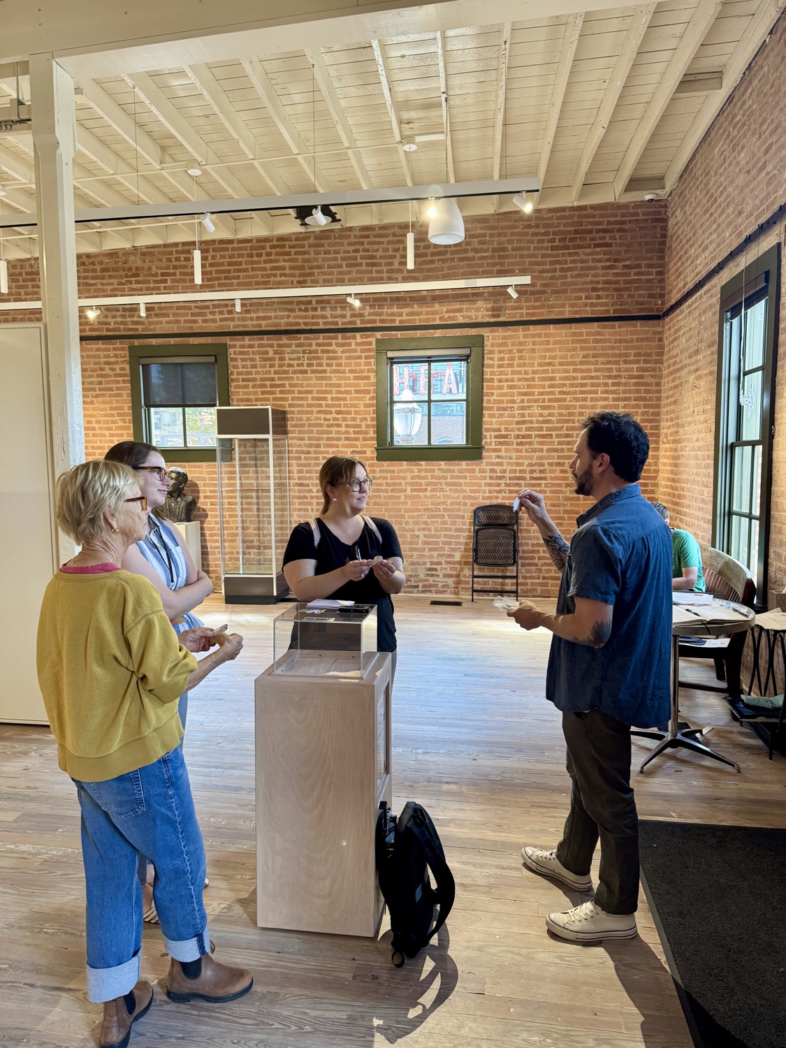 Dylan Yarter talking with the curator inside the Alexander Gallery during Our Art 2026 installation